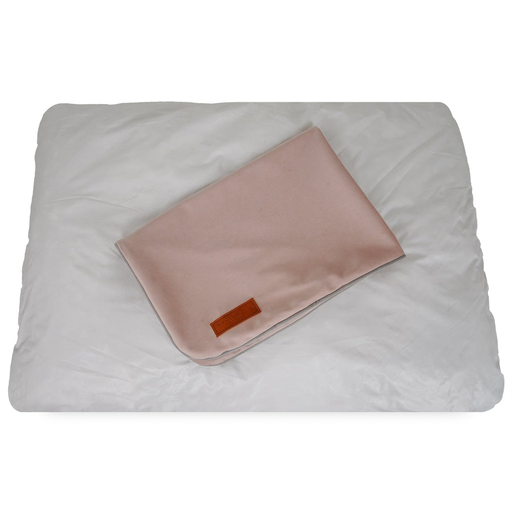 Removable pink cover folded on top of the white inner pad of the crate mattress