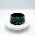 Green marble pet bowl with dark veining on a round white stand