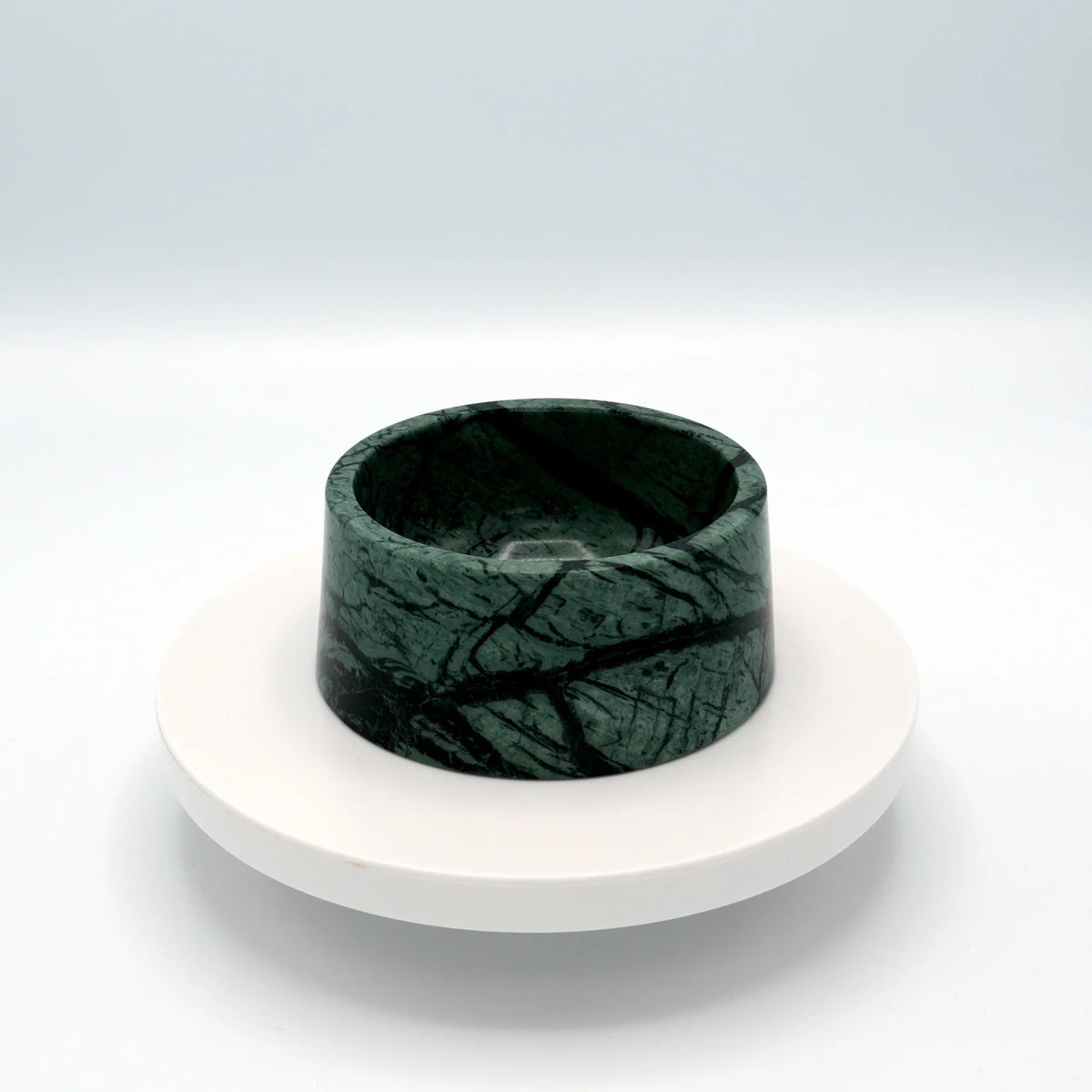 Green marble pet bowl with dark veining on a round white stand