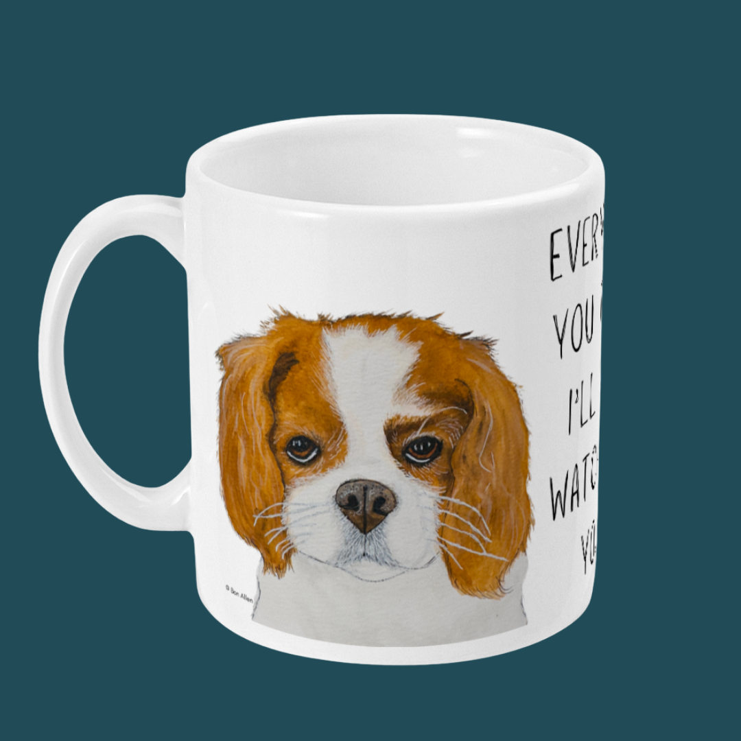 White mug with a Cavalier King Charles Spaniel portrait and slogan text on a dark teal background