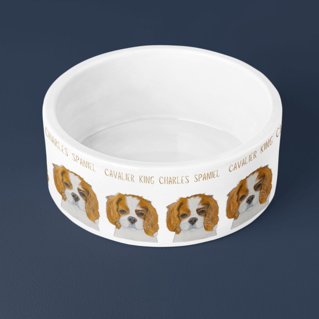 Top view of the white Cavalier King Charles Spaniel ceramic dog bowl showing its glazed inside, on navy