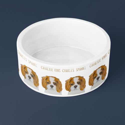 Top view of the white Cavalier King Charles Spaniel ceramic dog bowl showing its glazed inside, on navy