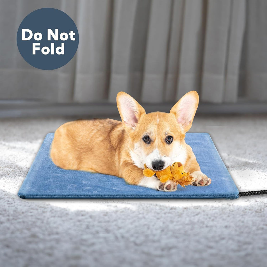 Corgi with a toy lying on a blue heated pet mat, with do-not-fold note