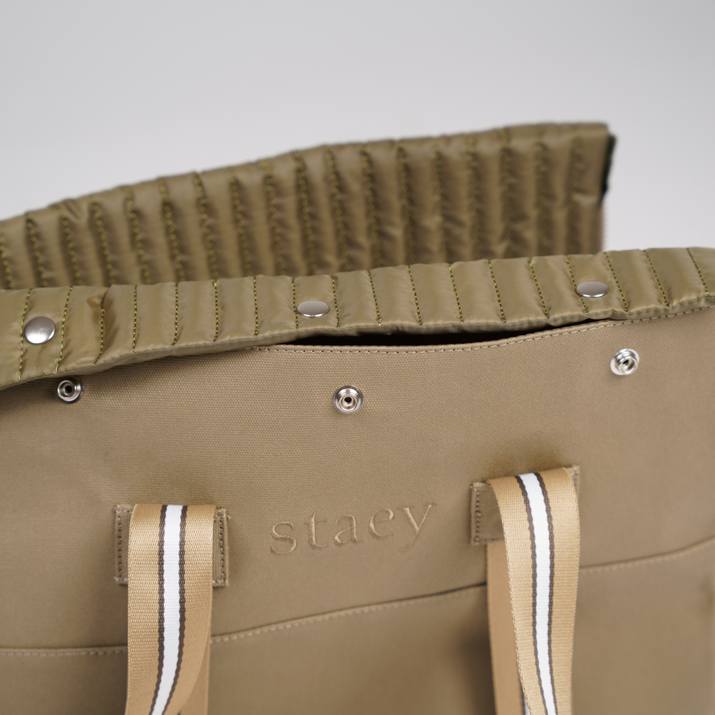 Close-up of the quilted fold-over top, snap buttons and striped straps
