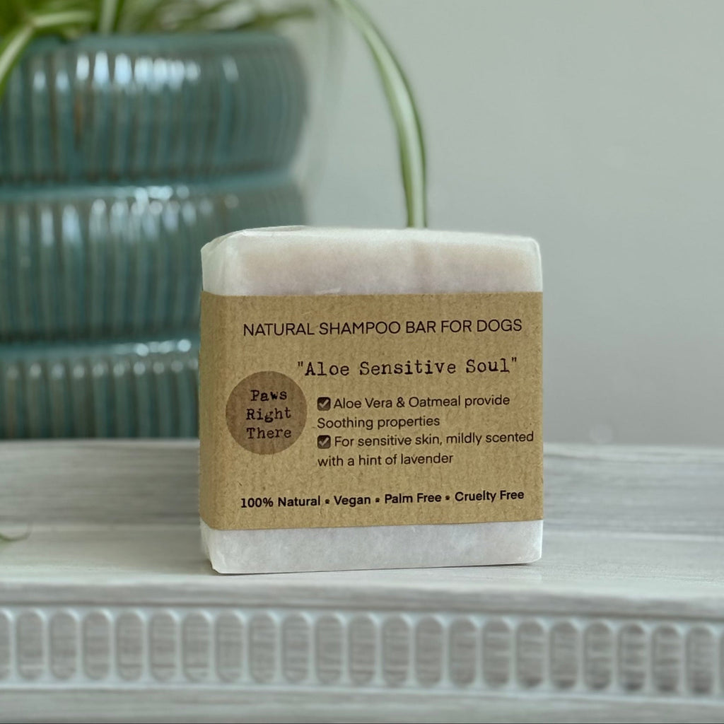 Aloe Sensitive Soul dog shampoo bar with kraft paper label on a white tray