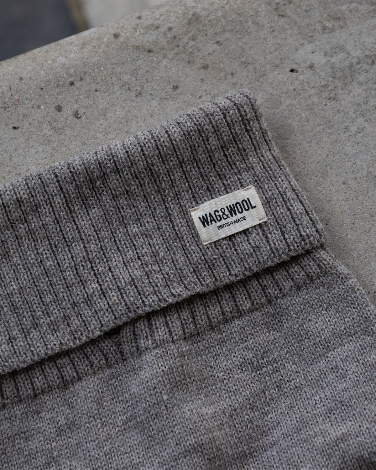 Close-up of the grey ribbed roll neck with WAG&WOOL label