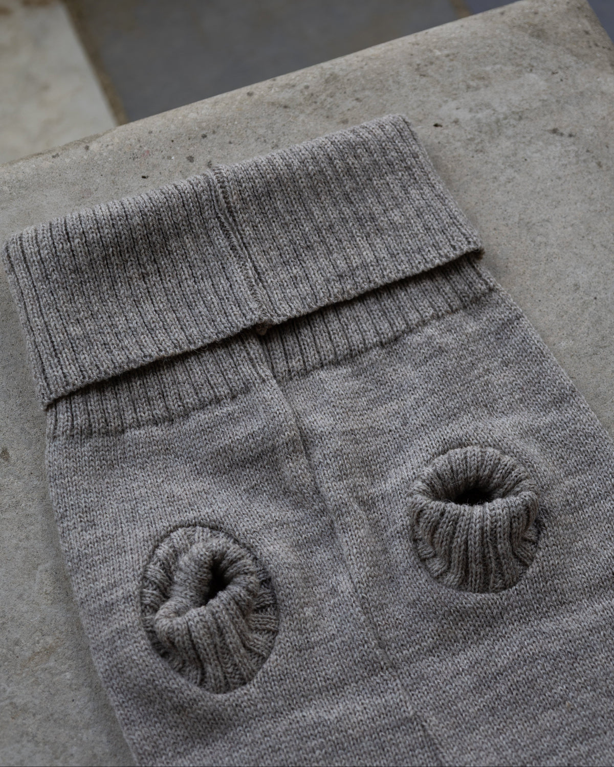 Grey wool dog jumper laid flat showing ribbed leg holes