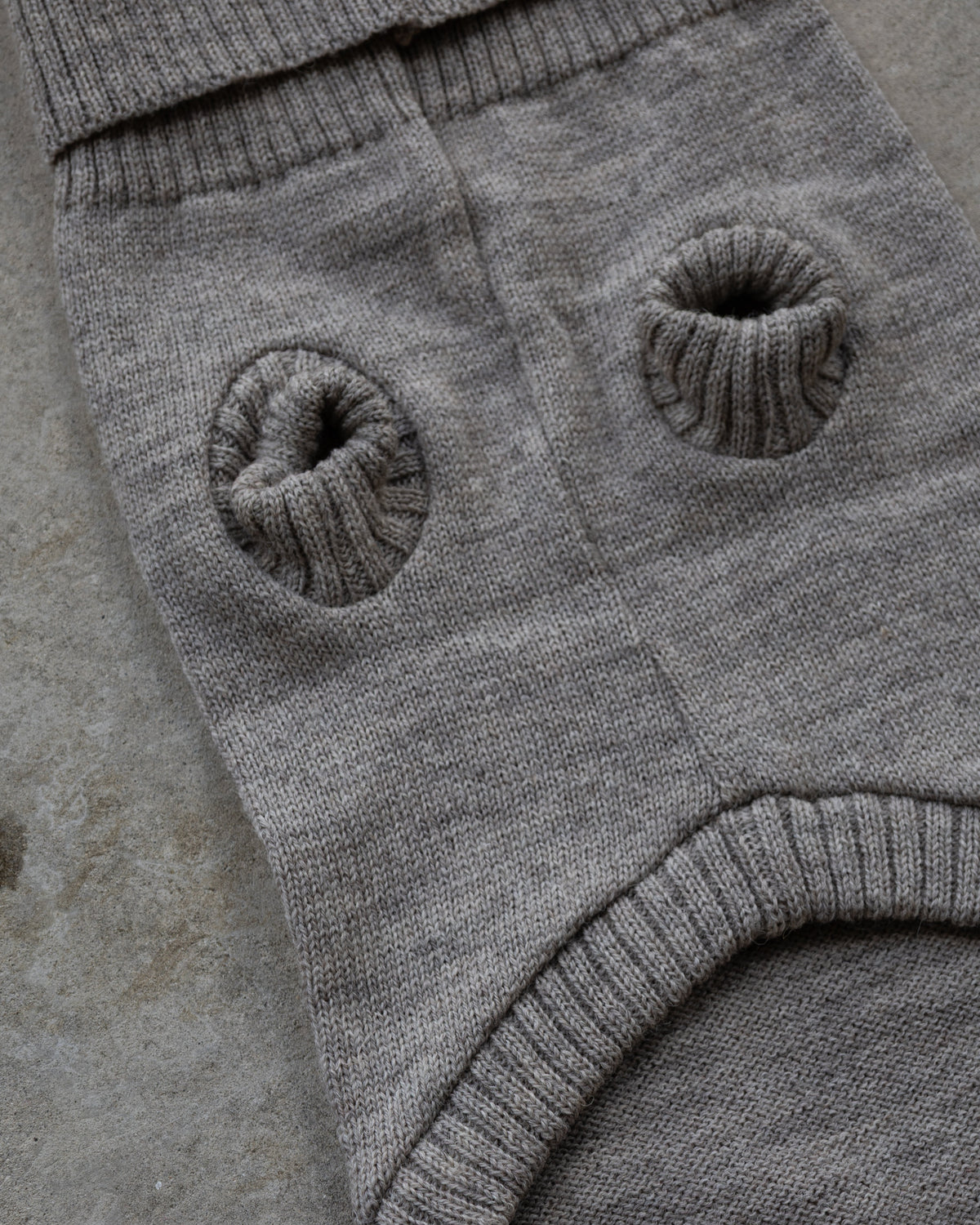 Underside of the grey wool dog jumper with leg openings