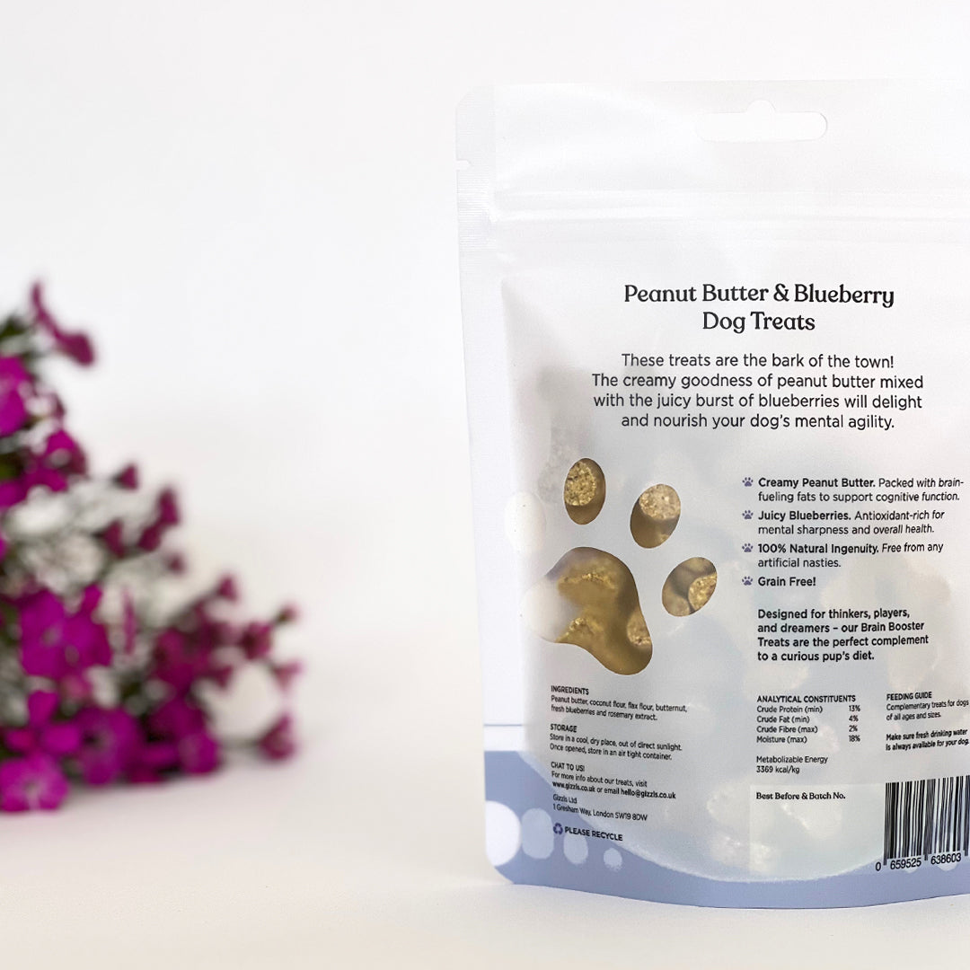 Back of the Gizzls Brain Booster 100g pouch with clear window showing peanut butter biscuits