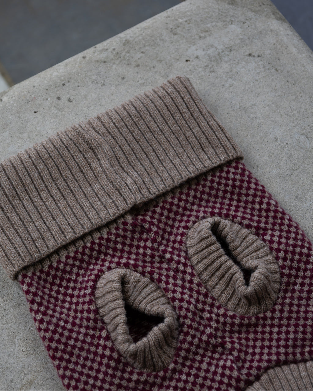 Underside of the burgundy check merino jumper with taupe leg cuffs