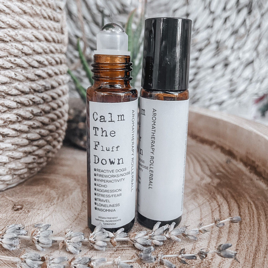 Two 10ml amber aromatherapy rollerball bottles for dogs with dried lavender