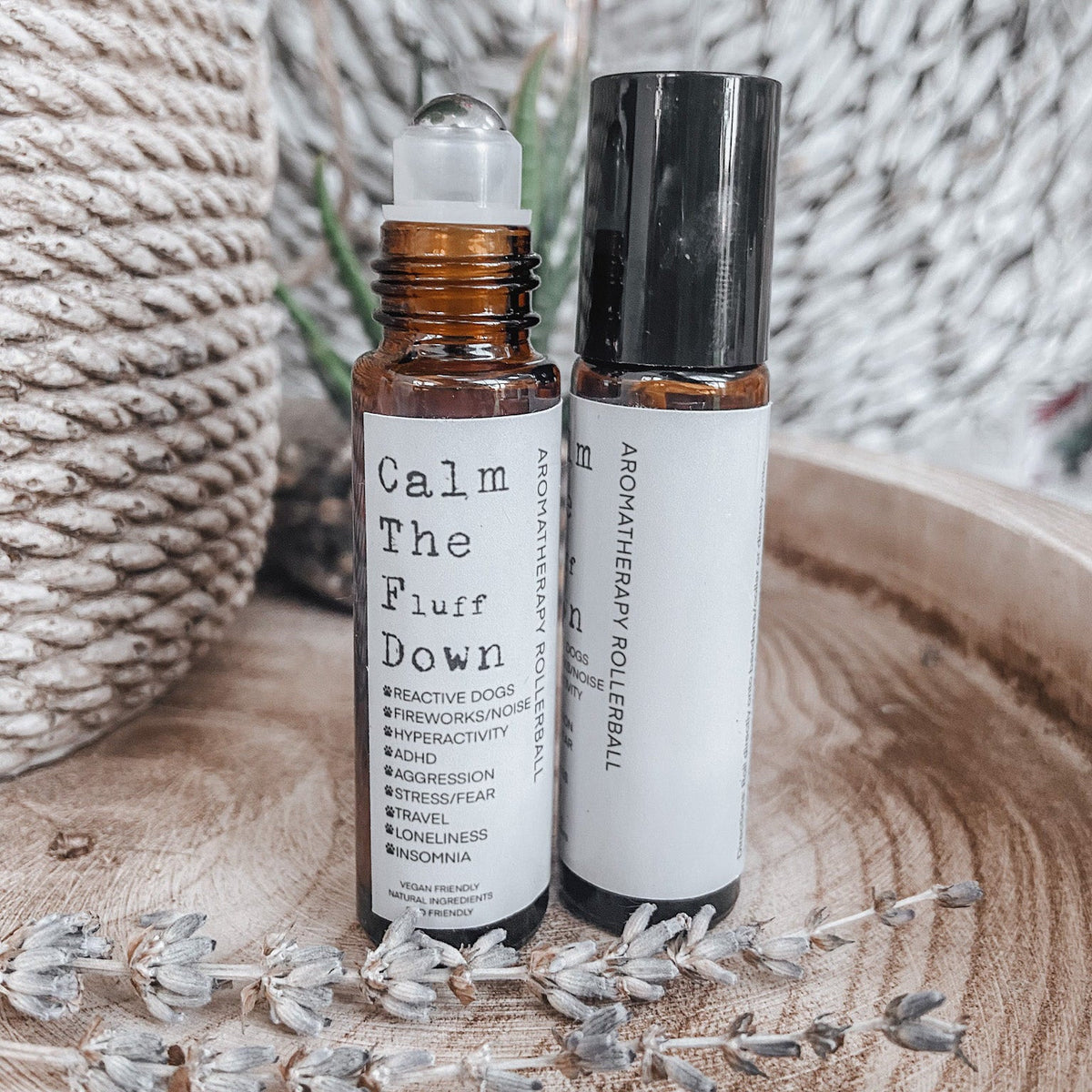 Two 10ml amber aromatherapy rollerball bottles for dogs with dried lavender
