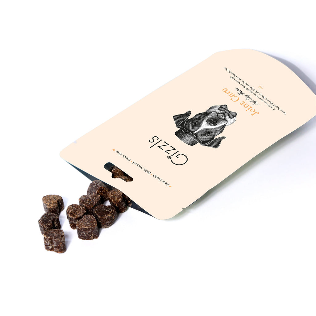 Open Gizzls Joint Care pouch with small dark soft treats spilling out