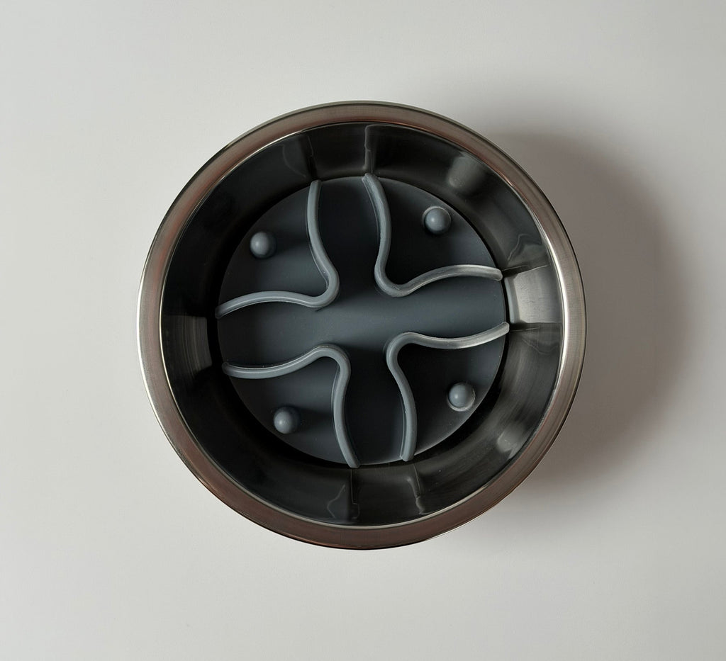 Overhead view of stainless steel dog bowl holding a grey silicone slow feeder