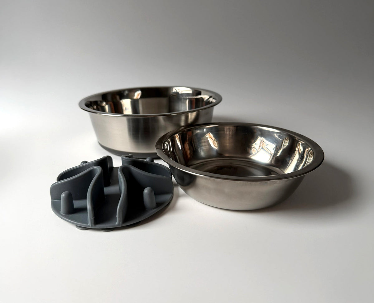 Two Snoofs & Boo stainless steel dog bowls beside a grey silicone slow feeder insert