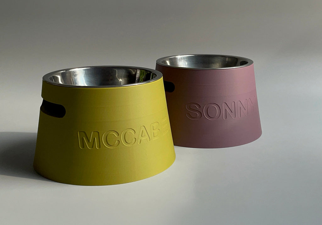 Short classic raised stands in mustard yellow and dusky pink with steel bowls