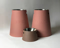 Two Classic Raised Dog Bowl Stands 30cm in dusky pink beside a short brown stand