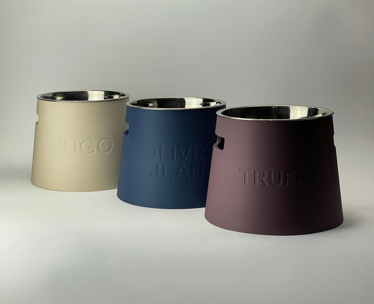 Classic raised dog bowl stands in cream, navy blue and plum with embossed names