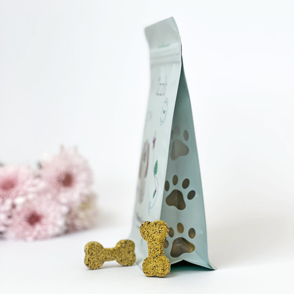 Minty Fresh Big Dog Treats pouch side-on with paw window and two biscuits