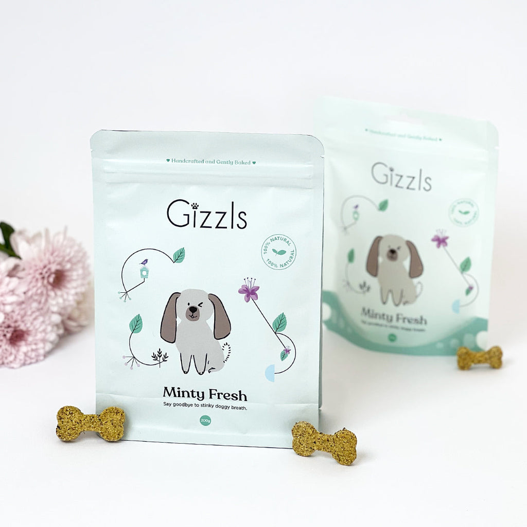 Two Minty Fresh pouches with bone-shaped biscuits and pink flowers