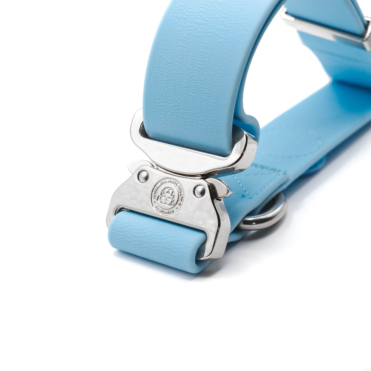 Close-up of the silver BTactical quick-release buckle on the pastel blue PVC collar