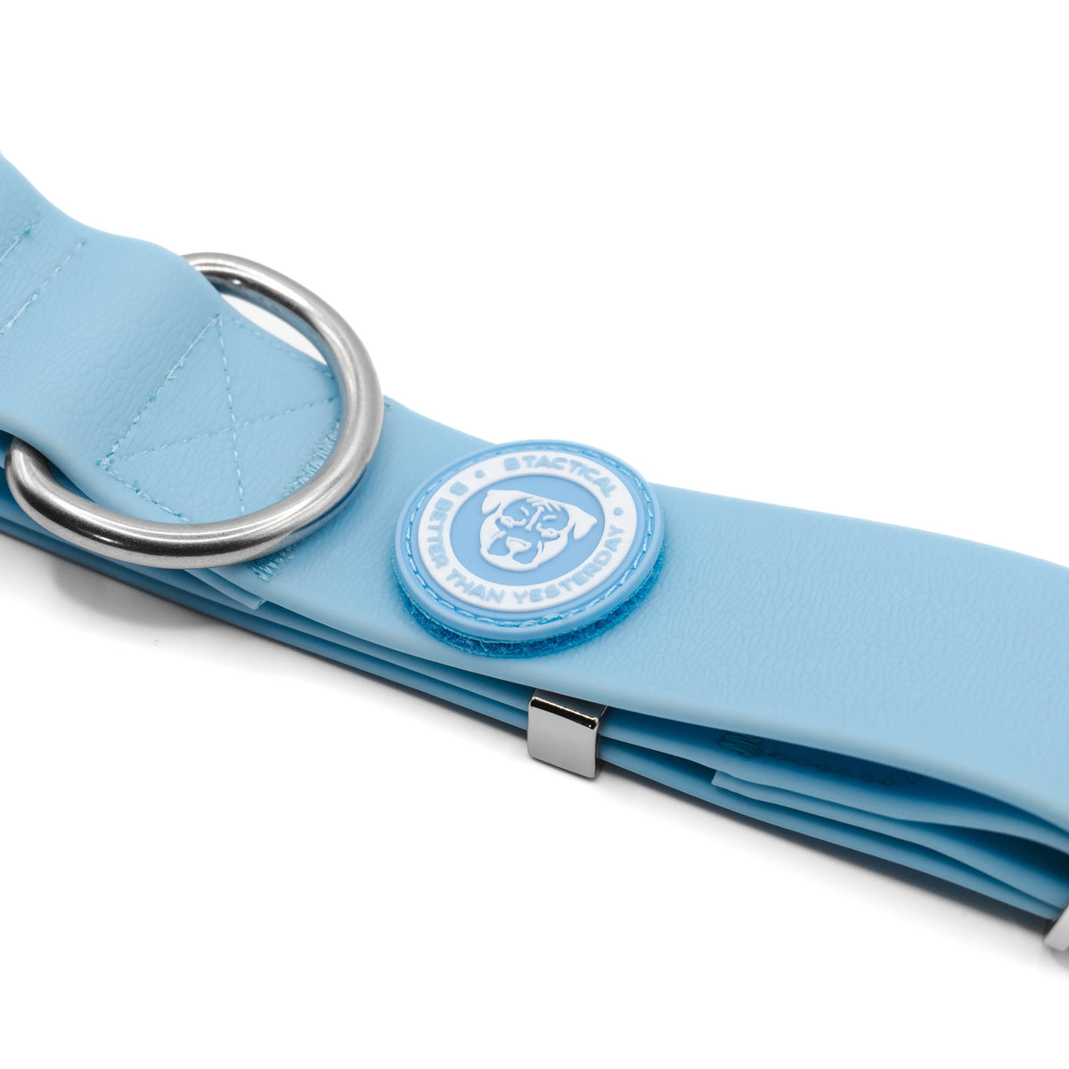 Detail of the D-ring and blue BTactical logo patch on the pastel blue PVC collar