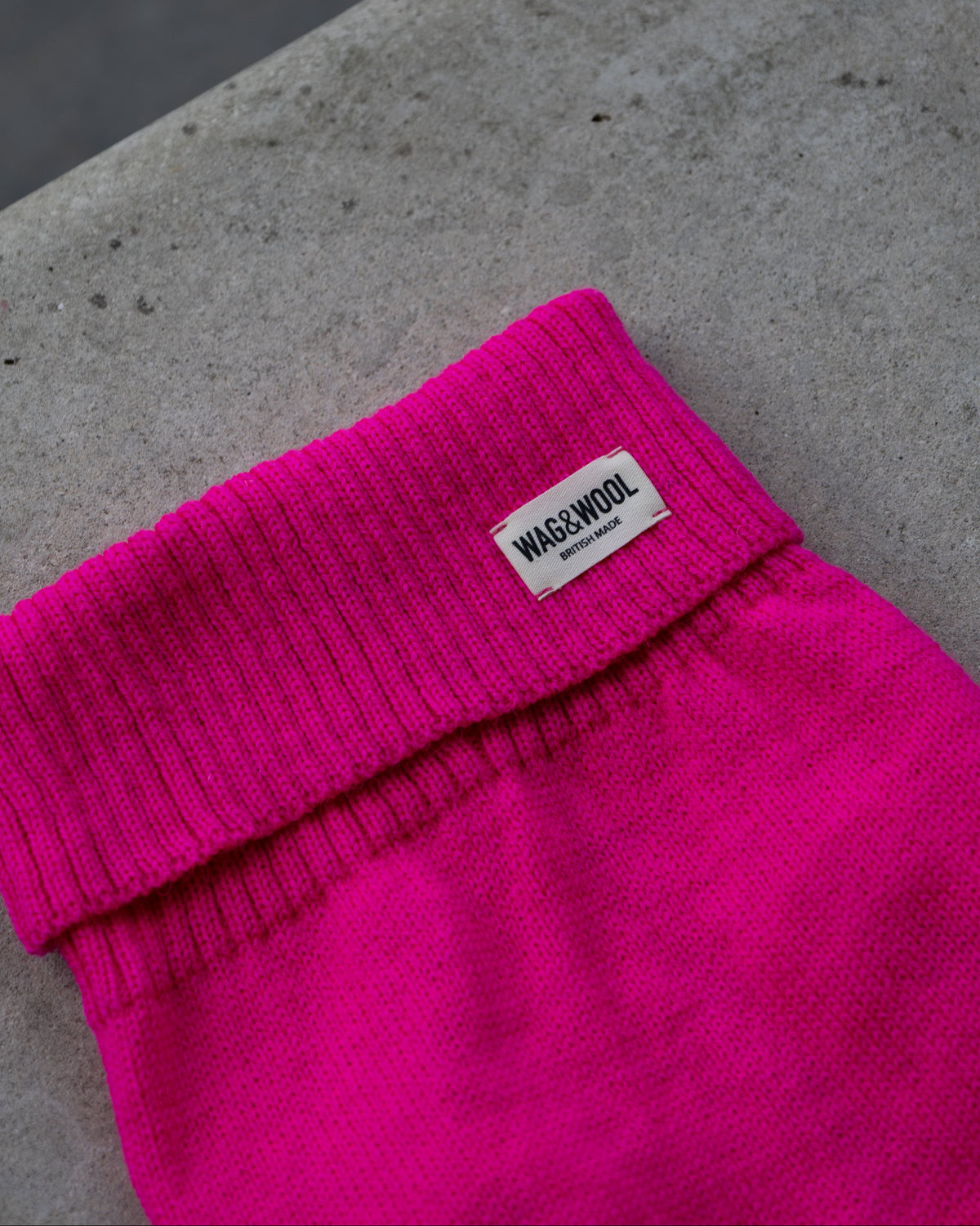 Close-up of the fandango pink roll neck with WAG&WOOL label