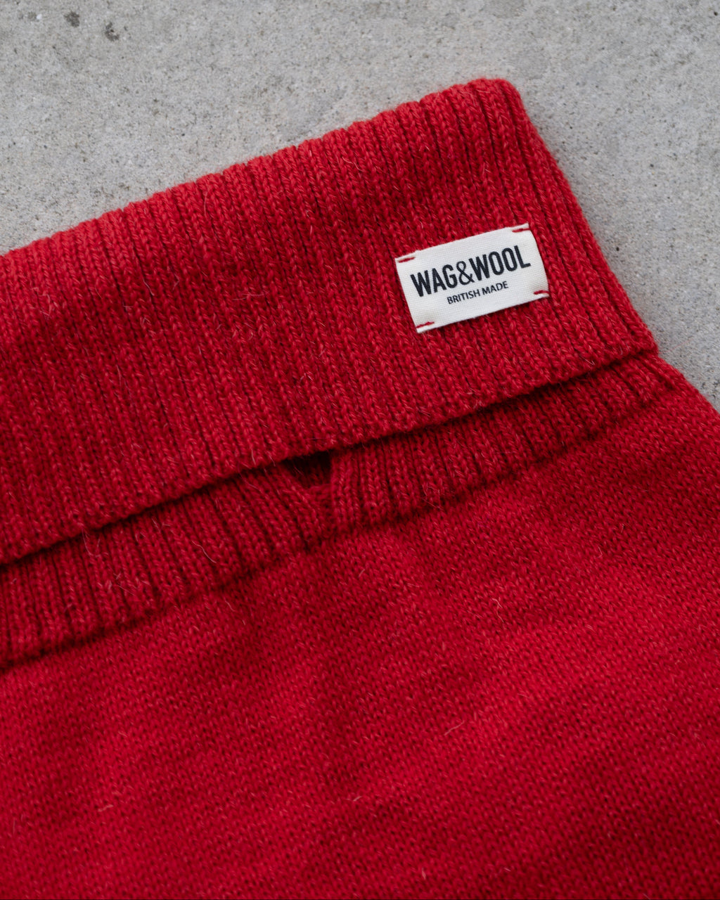 Close-up of the cherry red roll neck with WAG&WOOL label