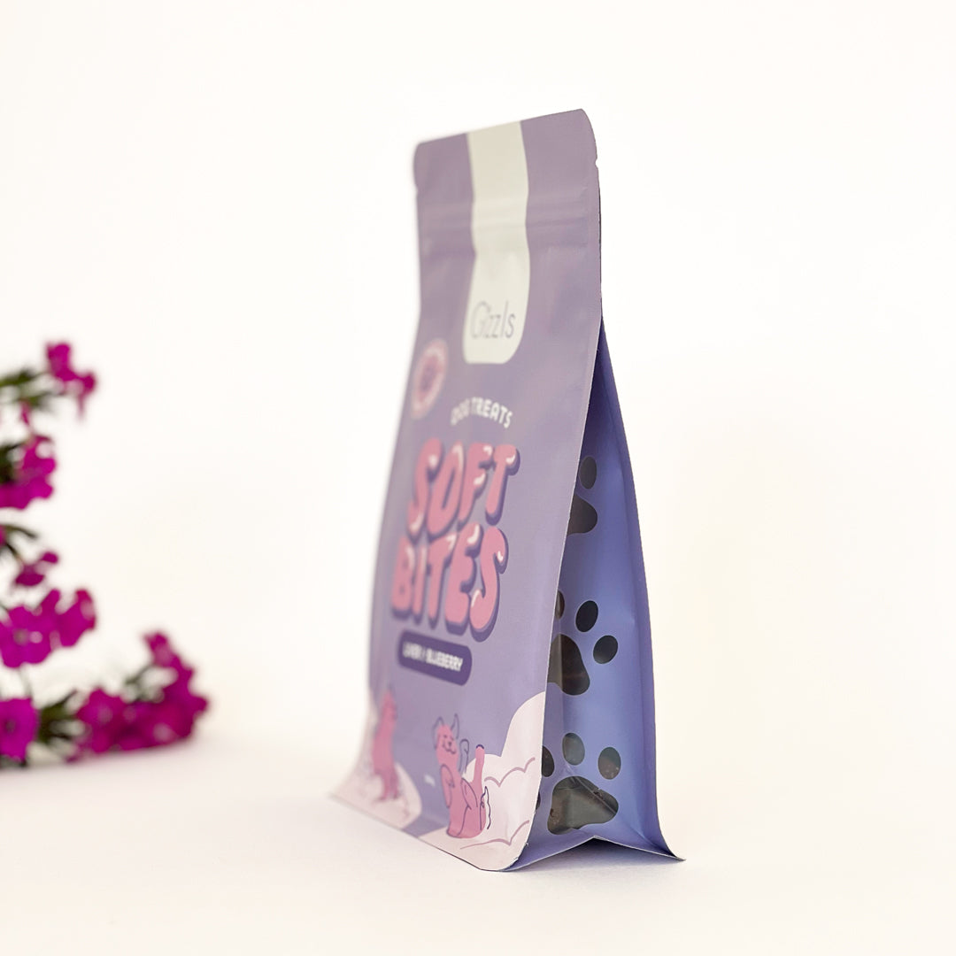 Side view of the Soft Bites Ostrich Liver & Blueberry pouch with paw-print window