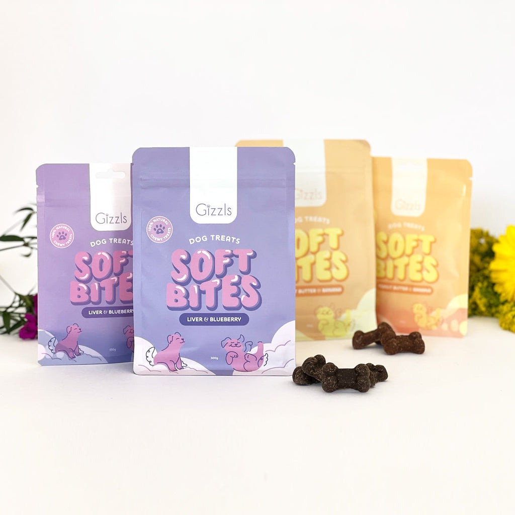 Range of purple and yellow Soft Bites pouches with treats and flowers
