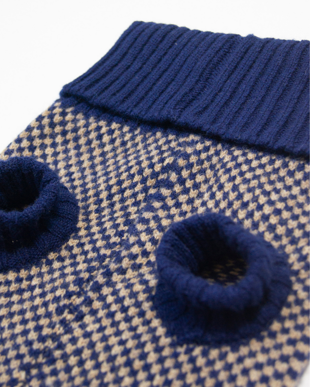 Close-up of the navy check knit and ribbed leg holes