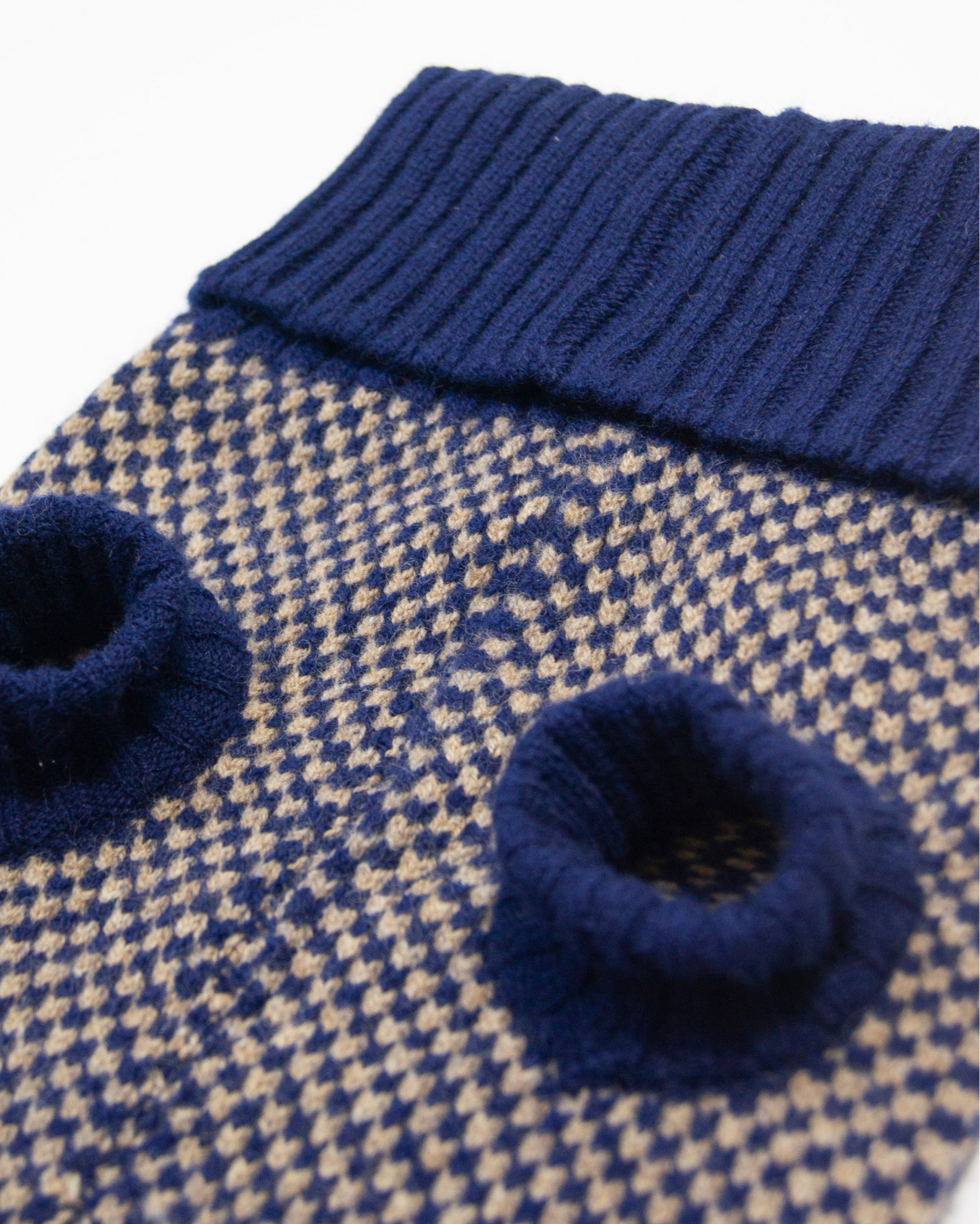 Close-up of the navy check knit and ribbed leg holes
