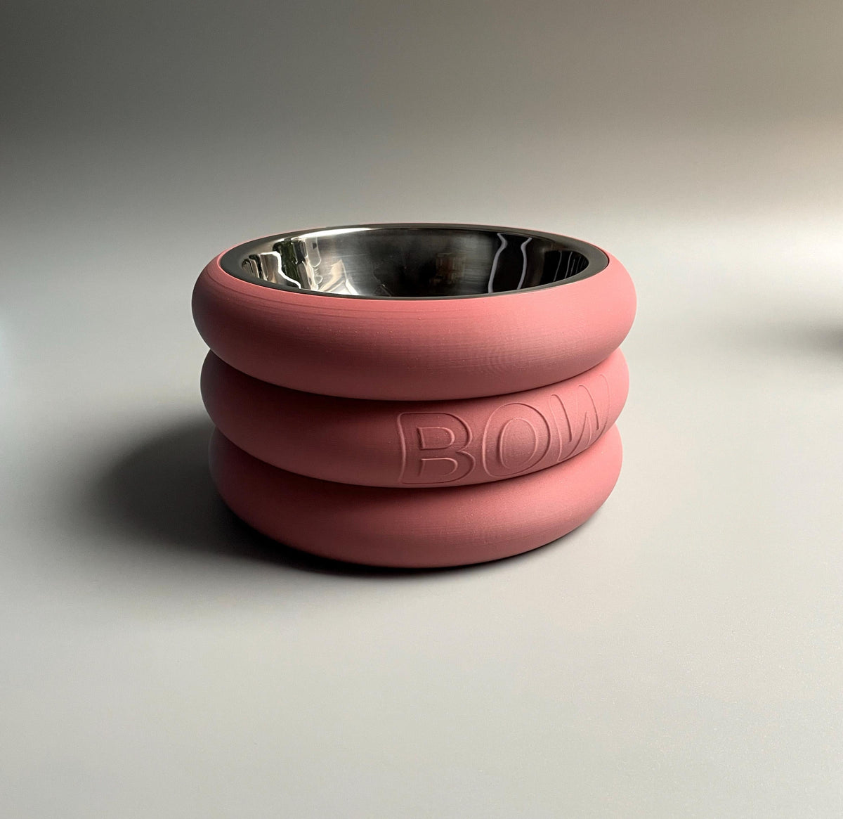 Short pink rings raised stand embossed BOW with a stainless steel bowl