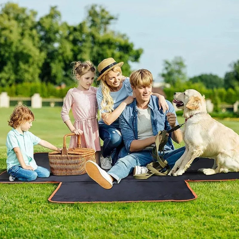 Family and golden retriever sitting on the liner used as a picnic mat