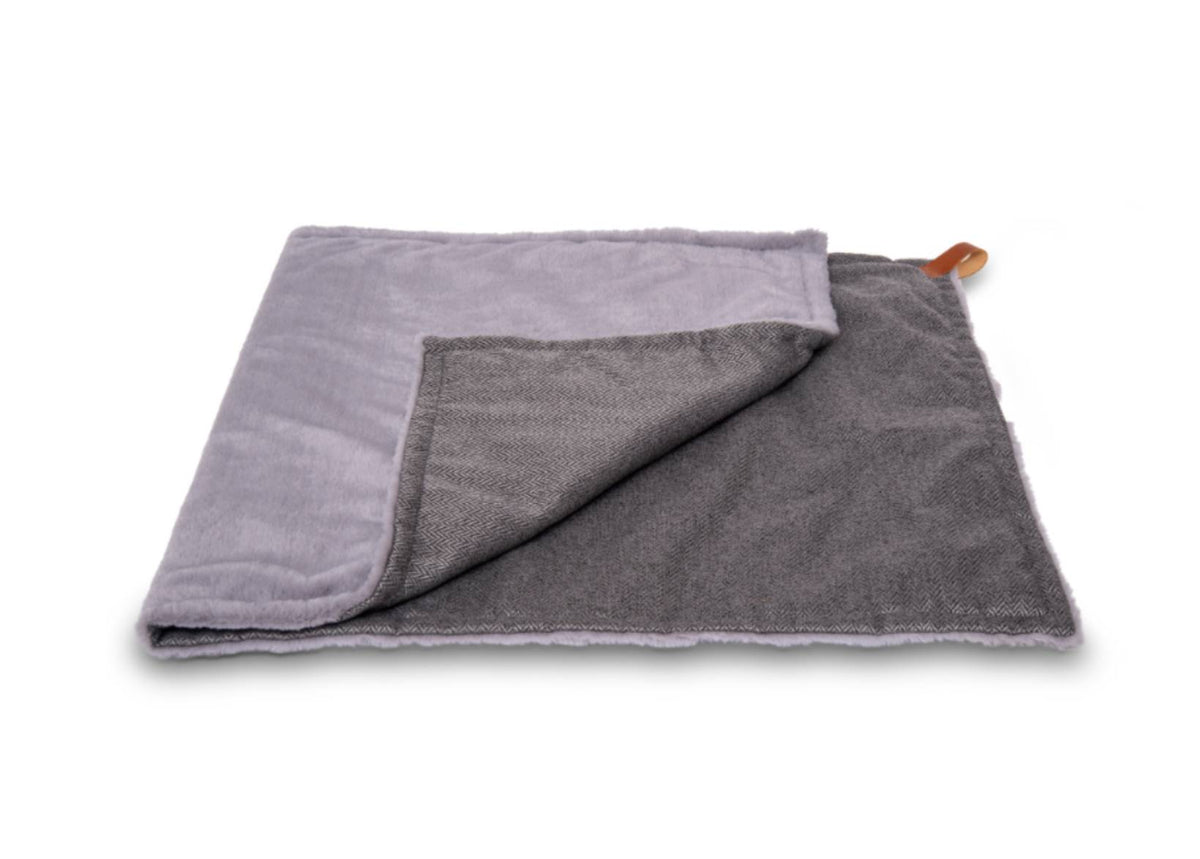 Balmoral reversible dog blanket folded to show grey herringbone tweed and grey faux fur