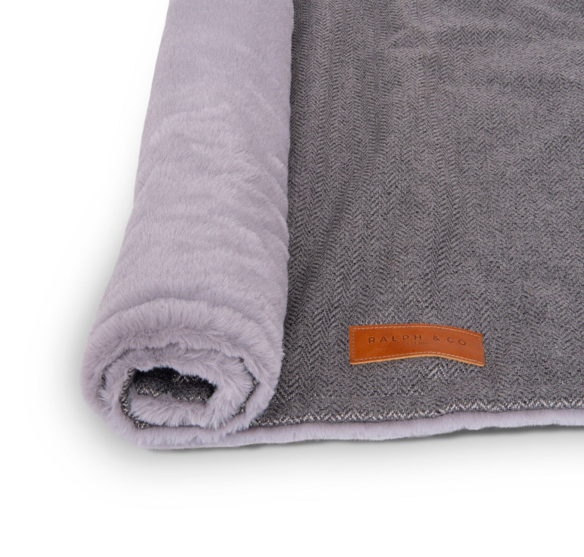 Balmoral grey herringbone and faux fur dog blanket rolled up with leather badge