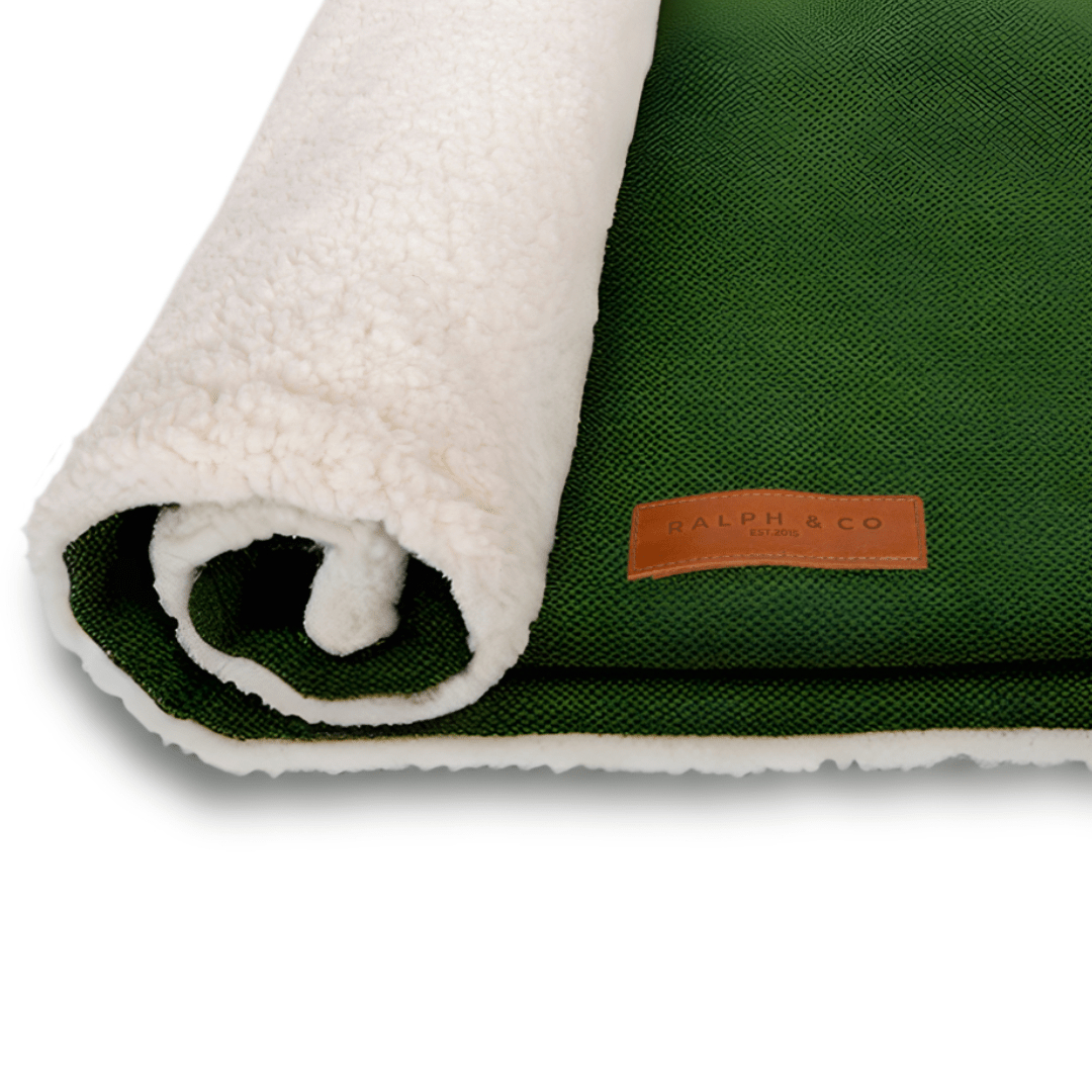 Richmond green and sherpa dog blanket rolled up with leather Ralph & Co badge
