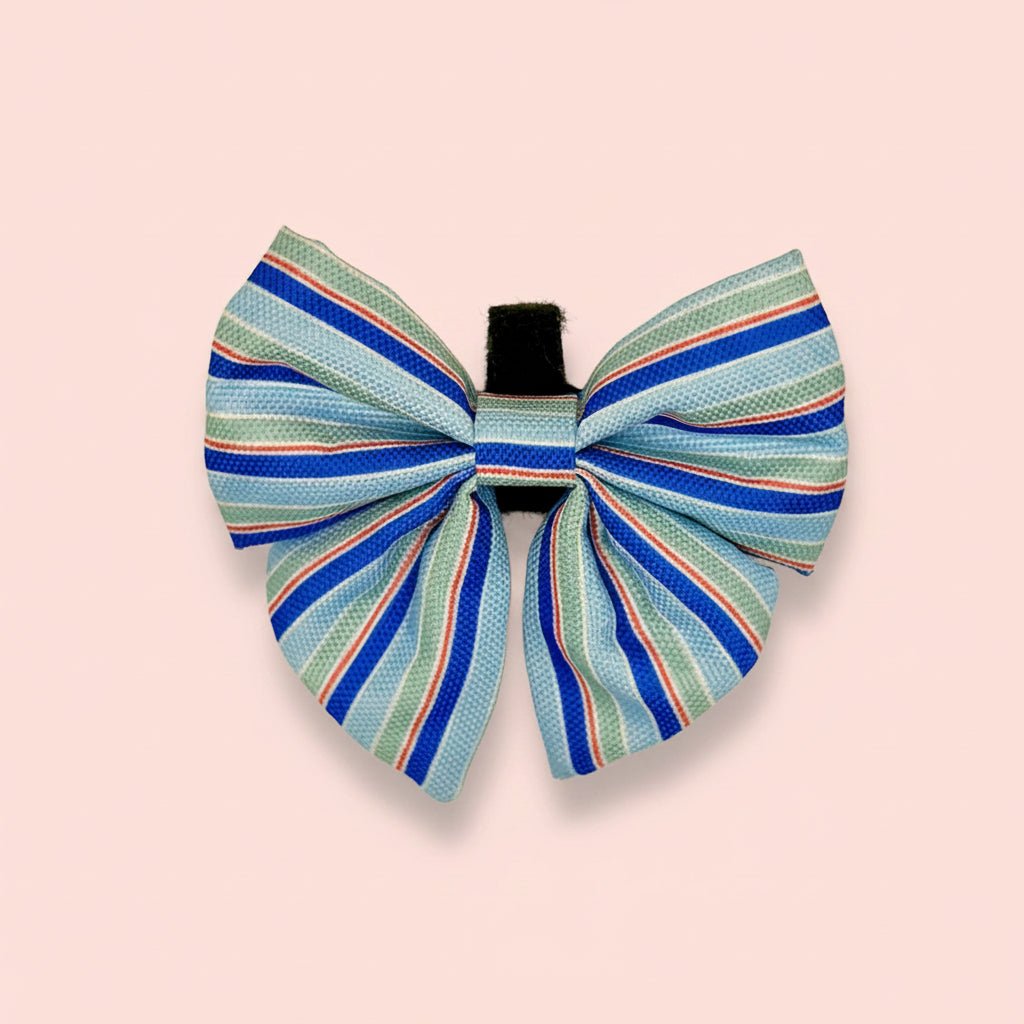 Sea Breeze Stripes Dog Sailor Bow in pale and royal blue stripes on a pink background