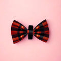 Red Tartan Dog Bow Tie in red, black and orange tartan on a pink background
