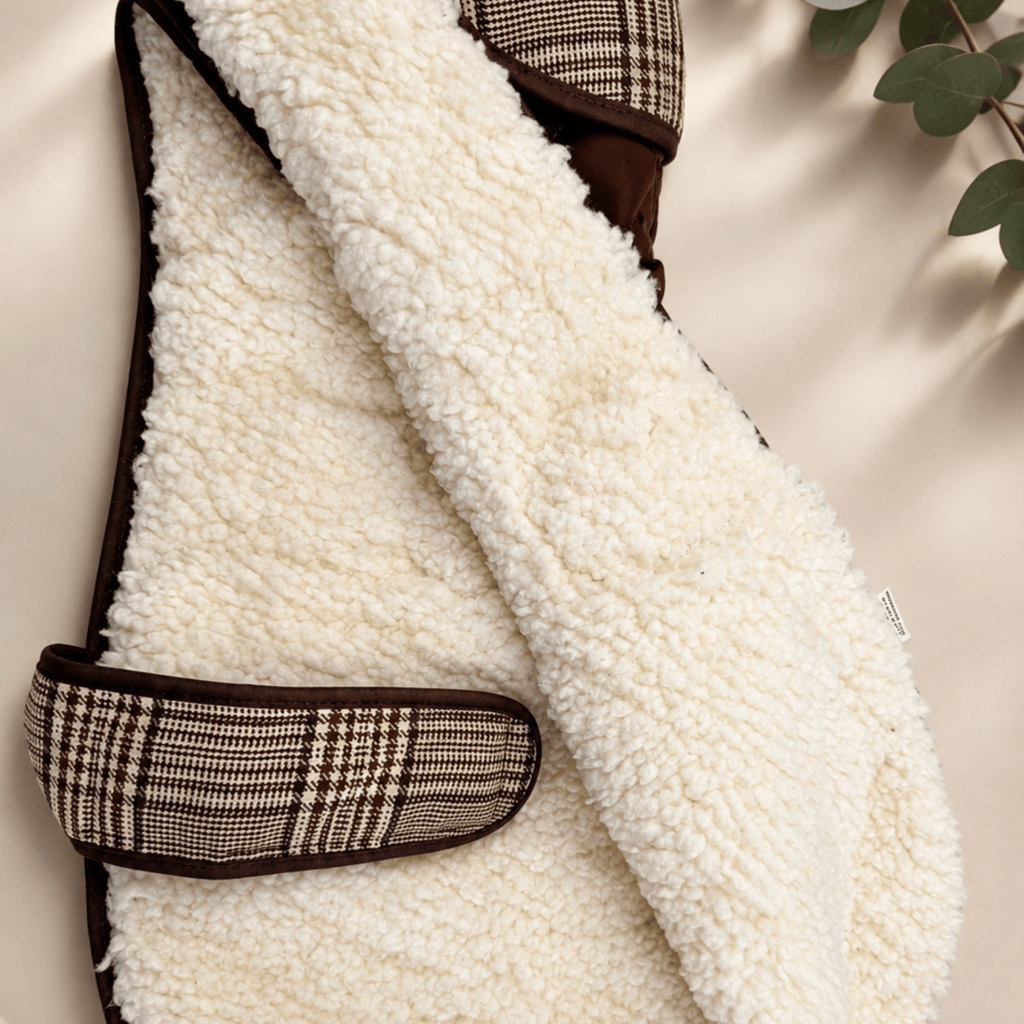 Inside of the Foxbury Plaid Quilted Dog Coat showing the cream teddy-fleece lining