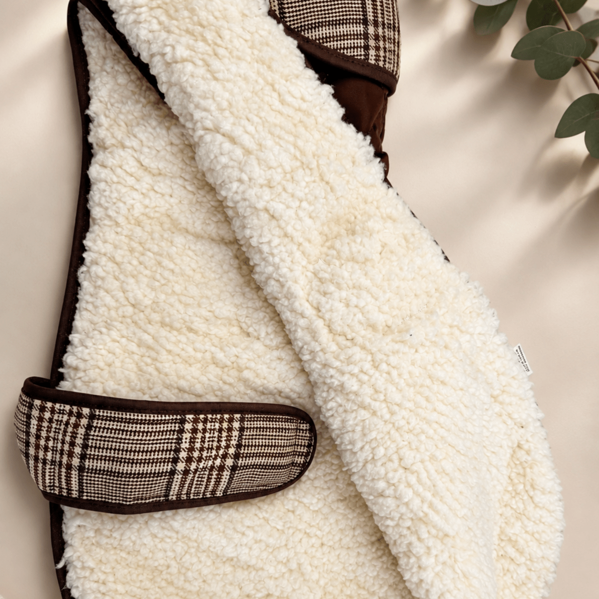 Inside of the Foxbury Plaid Quilted Dog Coat showing the cream teddy-fleece lining