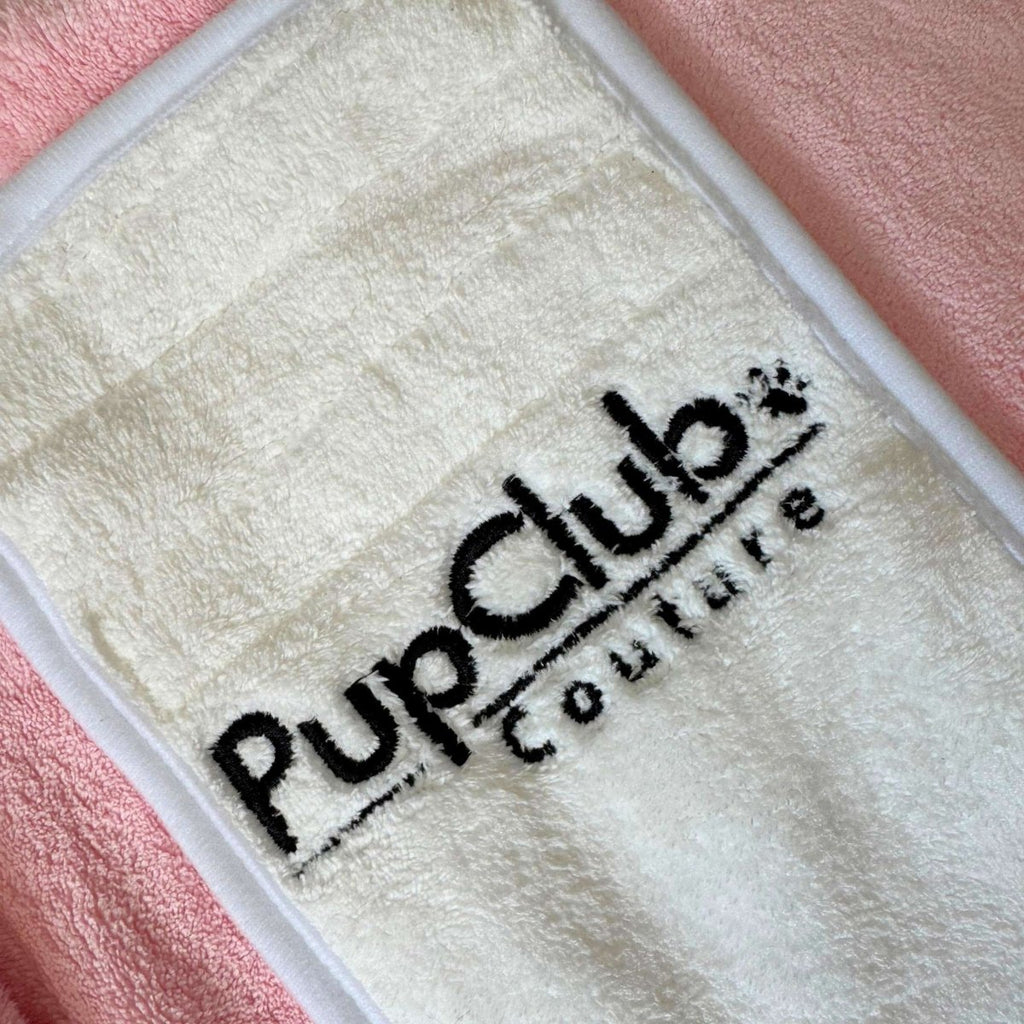Close-up of the cream velcro fastening with PupClub Couture logo on the Pink Dog Drying Robe