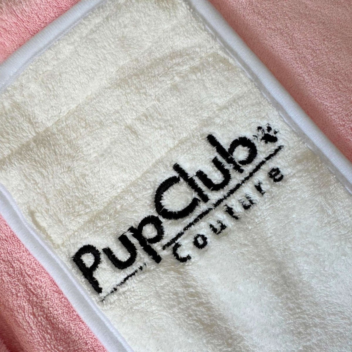 Close-up of the cream velcro fastening with PupClub Couture logo on the Pink Dog Drying Robe