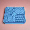 Blue Silicone Dog Lick Mat on a pink background showing textured patterns
