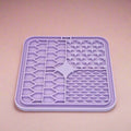 Lilac Silicone Dog Lick Mat on a pink background showing textured patterns