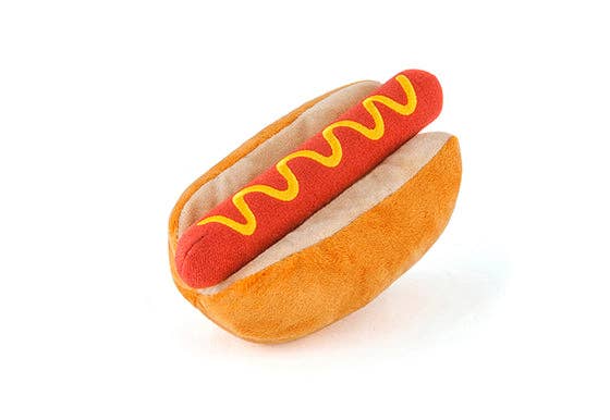 Plush hot dog dog toy with red sausage and yellow mustard in an orange bun