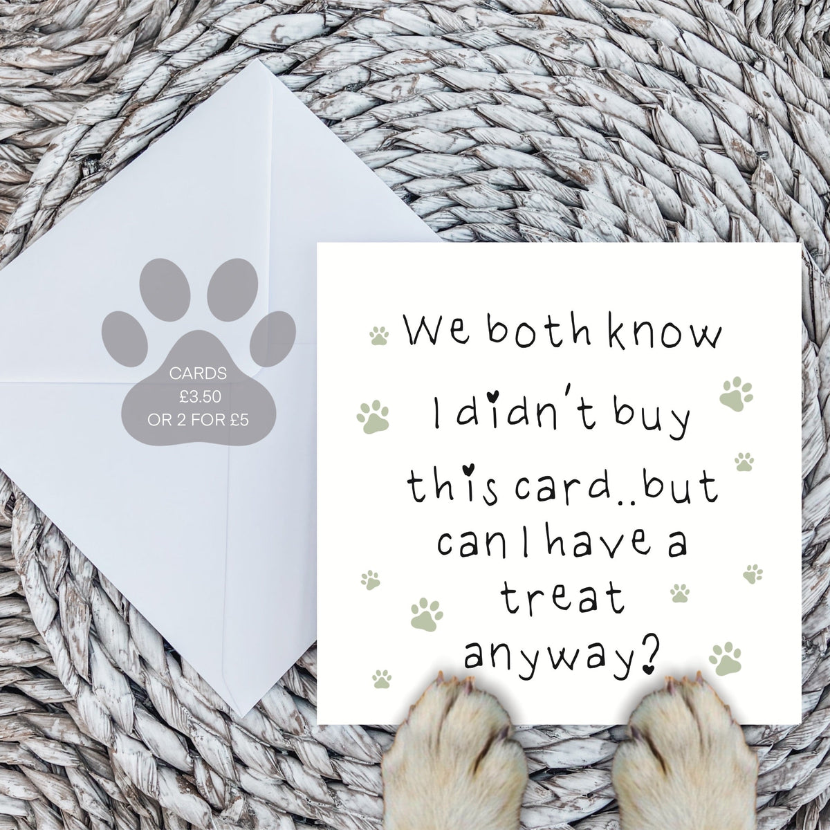 Funny dog card with paw print design, envelope and dog paws on a woven mat