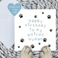 Blue Happy birthday to my weirdo human card with dog paws on a woven mat