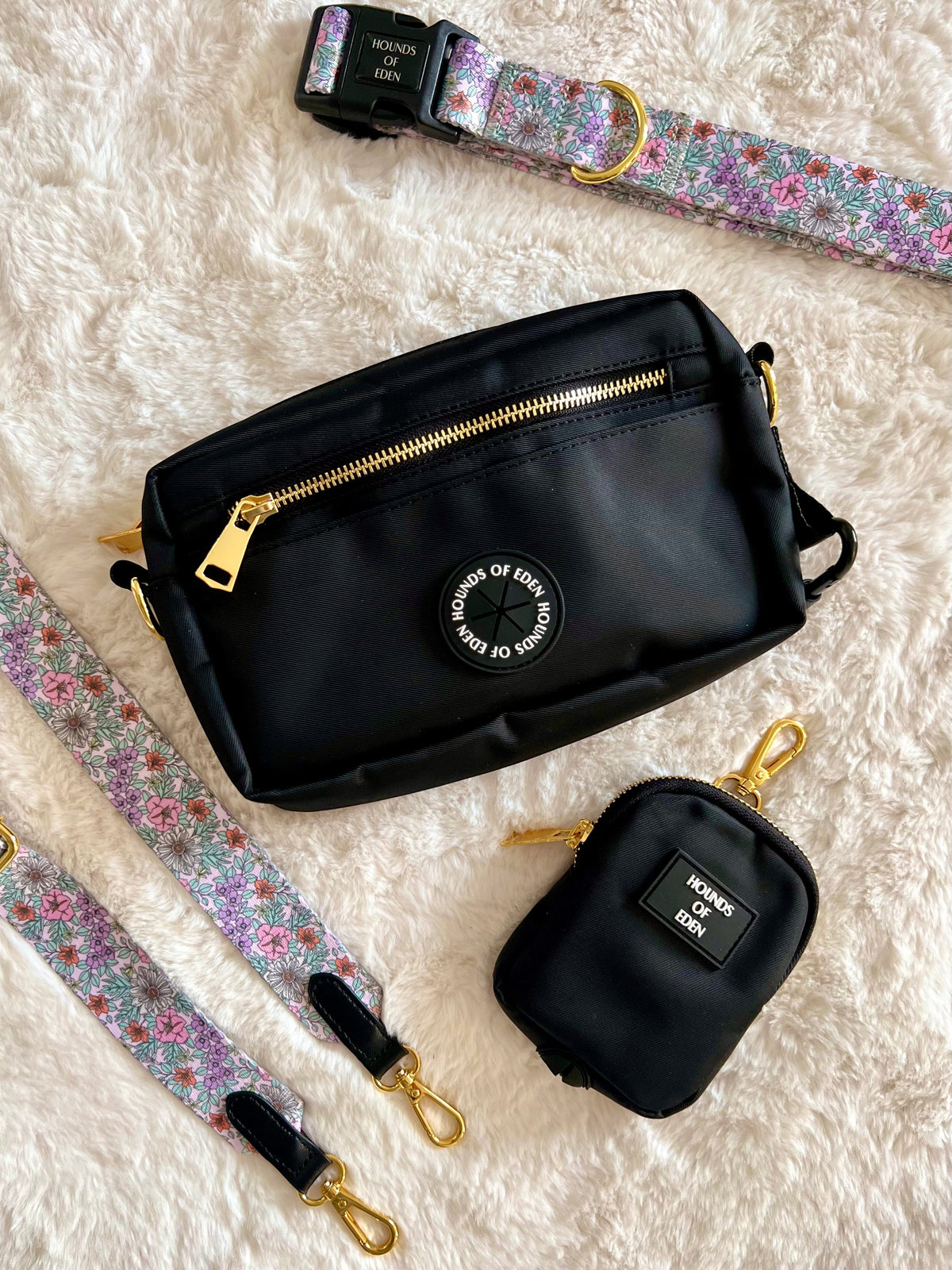 Black clip-on treat pouch beside a black walking bag and floral strap