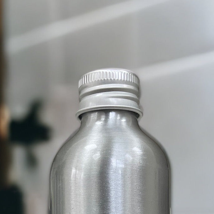 Close-up of the aluminium eco screw cap on a dog shampoo bottle